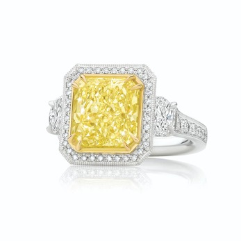 Ring with a 5.53ct radiant-cut yellow diamond surrounded by white diamonds