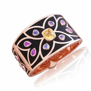 Cuff bracelet with an 8.46 carat cushion-cut yellow sapphire, blue sapphires and pink sapphires accentuated with black ceramic in 18k rose gold