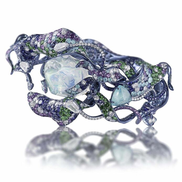 Vruta bracelet with an 18.35 carat water opal, a 1.94 carat Paraiba tourmaline, diamonds, purple and blue sapphires, tsavorite garnets in titanium, gold and custom rhodium finishes